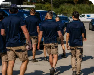 Plumbers walking to their service vans on a Winston Hills job
